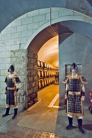 Two guards in ancient costume stand outside barrel cellar during Yantai Wine Festival at Changyu Castel winery Yantai Shandong Province China