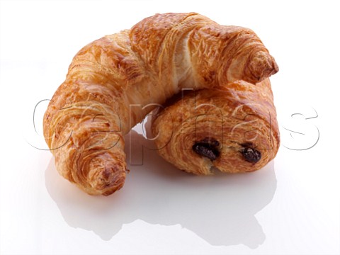 A pain au chocolat and croissant on a white background