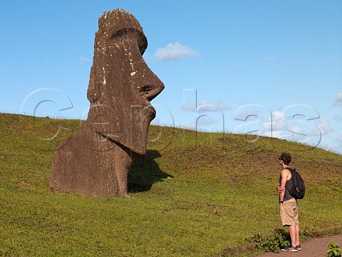Tourist looking at Moai on the Rano Raraku hill Easter Island
