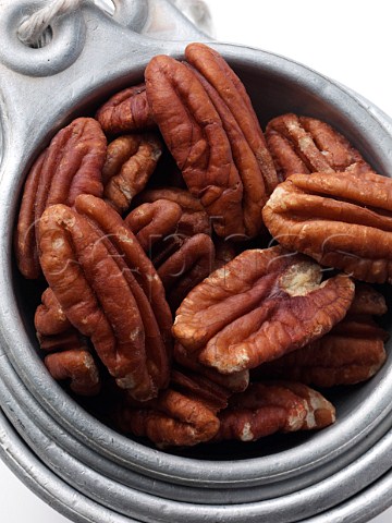 Pecan nuts in an antique measuring cup
