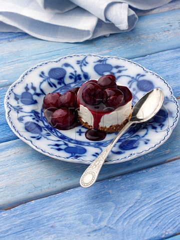 Individual cherry cheesecake on an antique plate
