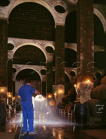 Spraying water on sandcovered floor to increase the humidity in the Cathedral Bodega of Antonio Barbadillo    Sanlcar de Barrameda Andalucia Spain   Manzanilla  Sherry