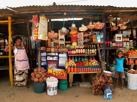 Woman and child on roadside stall selling food drinks etc Ponta do Ouro southern Mozambique