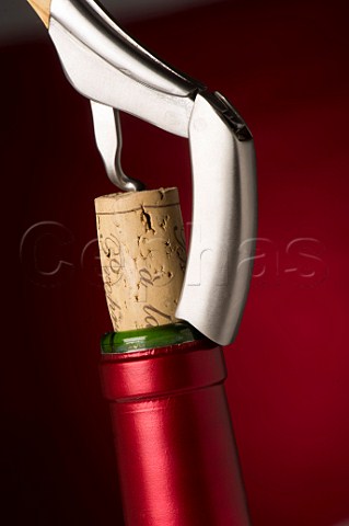 Removing the cork of a wine bottle with a Laguiole corkscrew