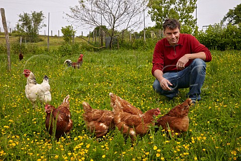 Emmanuel Houillon with chickens at Chaux deau the restored farm of Pierre Overnoy Pupillin near Arbois Jura France  ArboisPupillin