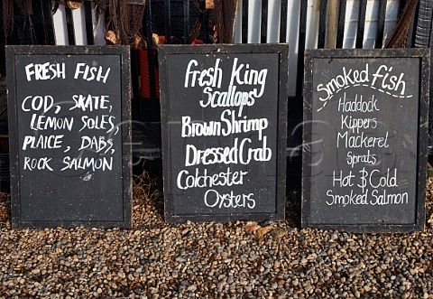 Boards advertising fish and shellfish for sale at Sole Bay Fish Company Southwold Harbour Suffolk England