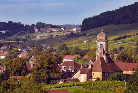 Collegiate Church of NotreDame in Arbois with village of MontignylsArsures in distance  Jura France Arbois