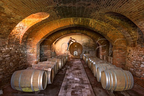 Paolo Dania filling the airlock of a botte in cellar of Dacapo  Agliano Terme Piemonte Italy Monferrato