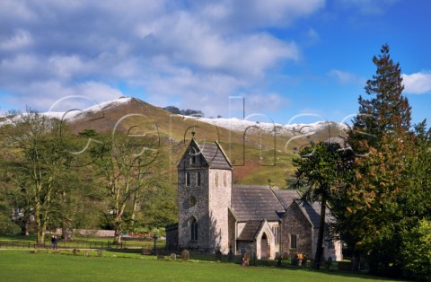 Church of the Holy Cross in Ilam Park with Bunster Hill beyond Ilam Staffordshire England  Peak District National Park