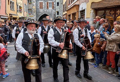 Men ringing cowbells during the Retour des Alpages festival Annecy HauteSavoie France