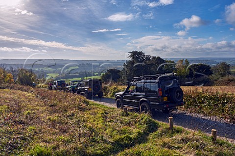 Land Rovers passing cyclists on a Byway Open To All Traffic at Newlands Corner on the North Downs Guildford Surrey England