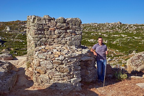 Michalis Kontizas by an old press house in the vineyards of Volacus Wine on the Volax Plateau  Falatados Tinos Greece