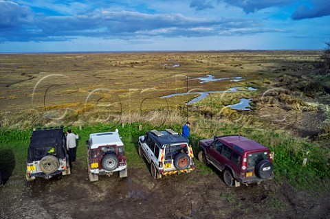 Land Rovers overlooking the salt marshes at Stiffkey Norfolk England