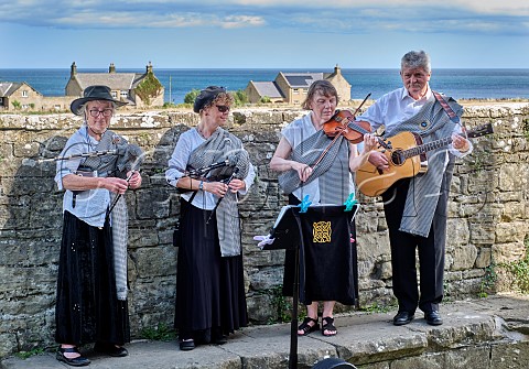 A band with two women playing Northumbrian smallpipes also viola and guitar  Cresswell Northumberland England