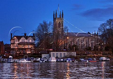 St Marys Church with Christmas lights and The Bell Inn viewed over the River Thames at dawn Hampton southwest London England