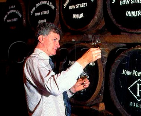 Barry Crockett Head Distiller checks on the   progress of his whiskey maturing in barrel Midleton   Distillery County Cork Eire