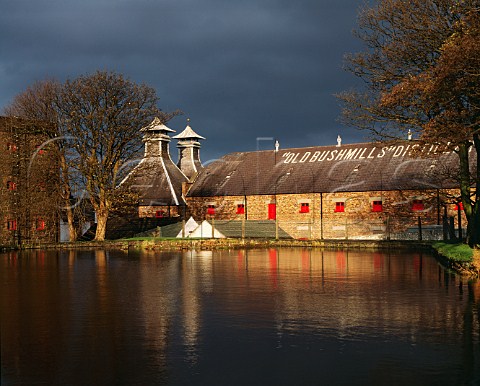 Pagodas and warehouse of the Old Bushmills   Distillery viewed over the dammed StColumbs Rill source of the water for the whiskey production   Bushmills Co Antrim Northern Ireland