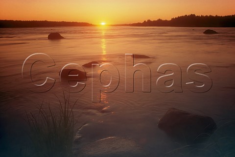 Midnight sun over the Tornio River north of the Arctic Circle Finland  The river here is the border between Finland and Sweden