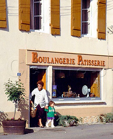 Woman and child coming out of Boulangerie in PulignyMontrachet Cte dOr France