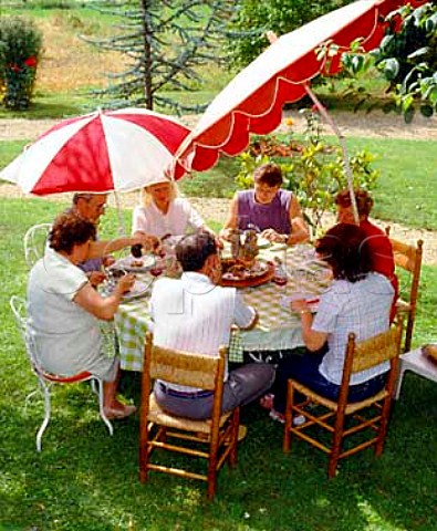 3 generations of French family at lunch in the   garden