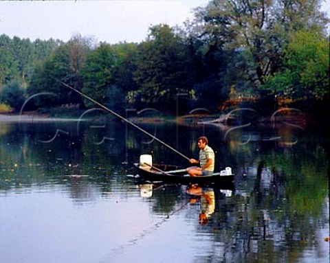 Fishing from a boat in the Dordogne River at Beynac   Dordogne France