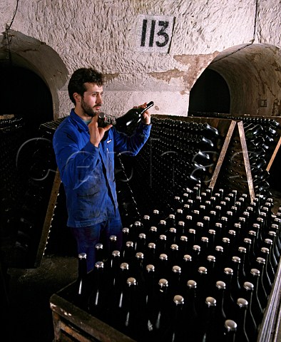 Champagne Veuve ClicquotPonsardin   Shaking bottles of La Grande Dame before putting in   pupitres to undergo the remuage   The cellars are in the old GalloRoman chalk quarries   of Reims Marne France