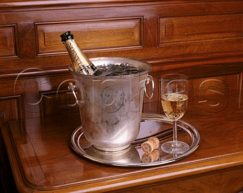 Bottle of Lanson Black Label Champagne in an ice bucket with glass and cork alongside