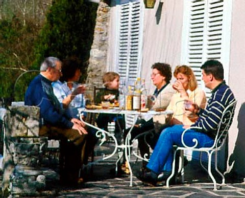 Four generations of the same French family have   aperitifs on the patio before Sunday lunch