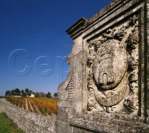 Crest in vineyard wall of Chteau Latour with Chteau PichonLonguevilleComtessedeLalande in distance Pauillac Gironde France Mdoc    Bordeaux