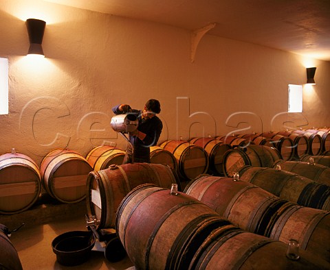 Topping up barrels after racking in the 1styear chai   of Chteau MoutonRothschild Pauillac Gironde   France    Mdoc  Bordeaux