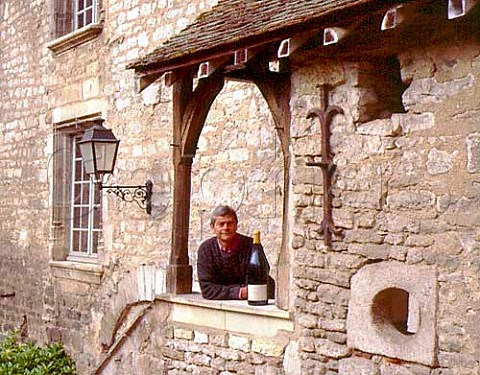 Michel Laroche with a Jeroboam of his Chablis Grand   Cru Les Blanchots in the courtyard of his   headquarters the Obediencerie in Chablis Domaine   Laroche Chablis Yonne France