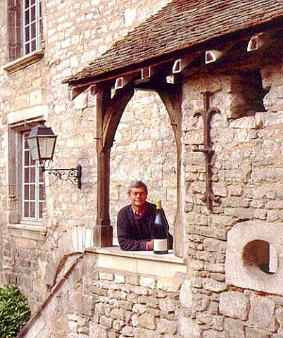 Michel Laroche of Domaine Laroche with a Jeroboam of   his Grand Cru Les Blanchots in the courtyard of his   headquarters the Obdiencerie in Chablis Yonne   France