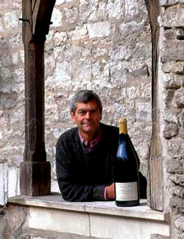 Michel Laroche with a Jeroboam of his Chablis Grand   Cru Les Blanchots in the courtyard of his   headquarters the Obediencerie  Domaine Laroche Chablis Yonne France