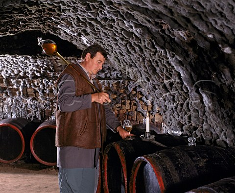 Gyula Borsos fills a tasting glass with wine  taken   from barrel with a pipette  in the ancient   mouldcovered cellars of Tokaj Kereskedhz Tolcsva   Hungary  Tokaji
