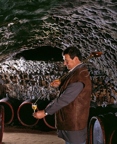 Filling a tasting glass with wine  taken from barrel with a pipette  in the ancient mouldcovered cellars of Tokaj Kereskedhz Tolcsva Hungary Tokaji    