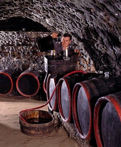 Racking wine in the traditional manner in the ancient mouldcovered cellars of   Tokaj Kereskedhz Tolcsva Hungary  Tokaji