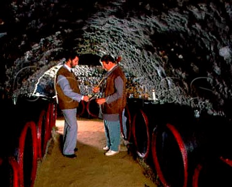 Gabor Egressy left and Gyula Borsos tasting wine   from barrel in the ancient mouldcovered cellars of   Tokaj Kereskedhz Tolcsva Hungary  Tokaji