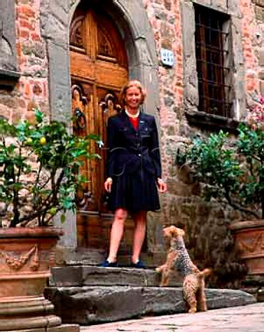 Giovannella Stianti Mascheroni with her dog   Peggy Lee at the entrance to the offices of Castello   di Volpaia in the medieval hamlet of Volpaia   Tuscany Italy  Chianti Classico