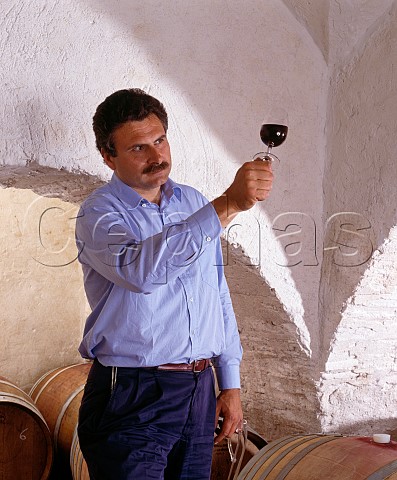 Consultant winemaker Maurizio Castelli checking a   sample of Balifico a vdt of Sangioveto Mammolo and   Cabernet taken from barrique in the cellars of   Castello di Volpaia Tuscany Italy