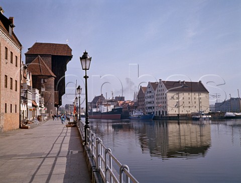 The Crane Gate and across the Motlawa River the   three restored granaries which form part of the   Central Maritime Museum complex Gdansk Poland