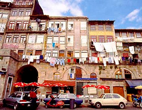 Caf on the Cais da Ribeira with laundry hanging out   to dry from the properties above This is the   waterfront area of the city by the Douro River   Porto Portugal