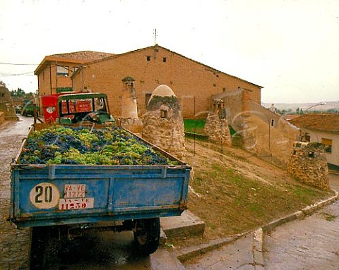 Trailer of harvested grapes awaits unloading at the Protos cooperative 1987  The ventilation shafts are from its cellars below the castle   Peafiel   Castilla y Len Spain  Ribera del Duero
