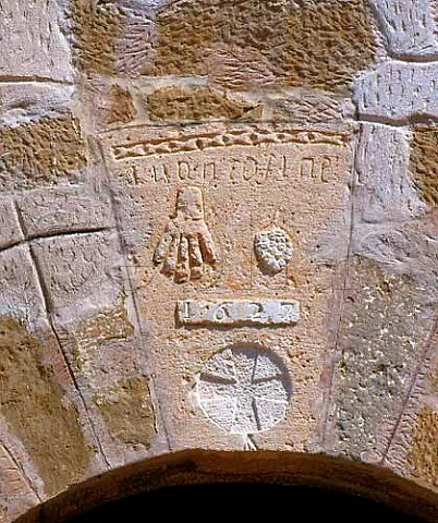 Bunch of grapes and a hand  the symbol of the   estate  above the entrance to the castle of Raimat   The name comes from the original Arabic words for   these  raim and mat   Lerida Catalonia Spain   Costers del Segre