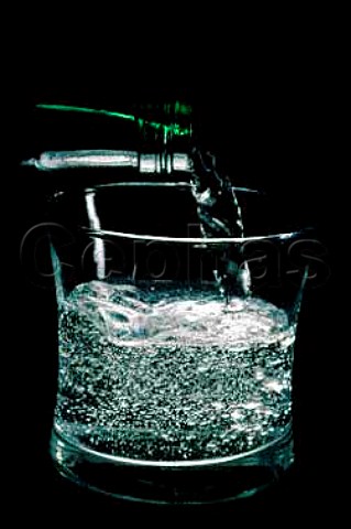 Pouring a glass of sparkling perrier   water