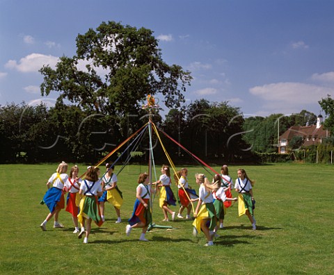 Young girls dancing round the maypole