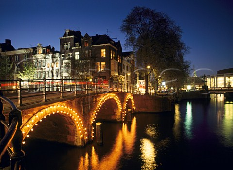 Small bridge over the Herengracht Canal at its confluence with the River Amstel Amsterdam Netherlands