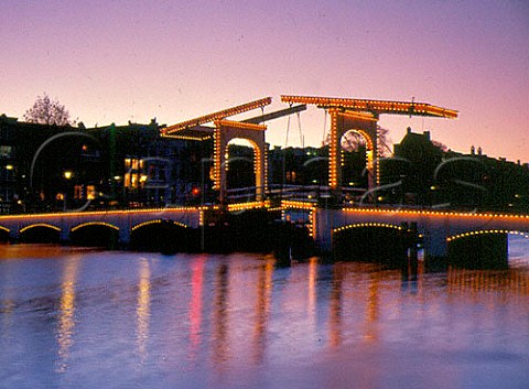 Magere Skinny Bridge crossing the river Amstel   in Amsterdam at dusk Netherlands