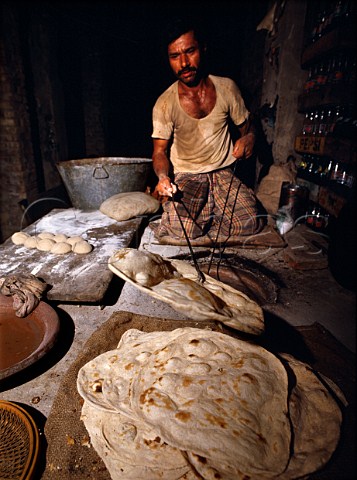Baker Cooking chapaties in tandoori oven Lahore   Pakistan