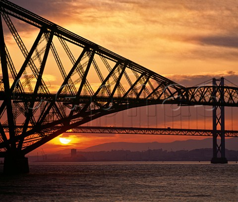 Forth Rail Bridge at sunset with the Road Bridge  beyond crossing the Firth of Forth between  Queensferry and Inverkeithing  Near Edinburgh Scotland