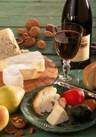South Africa Glass and bottle of Stellenbosch red wine with bread cheese fruit and nuts